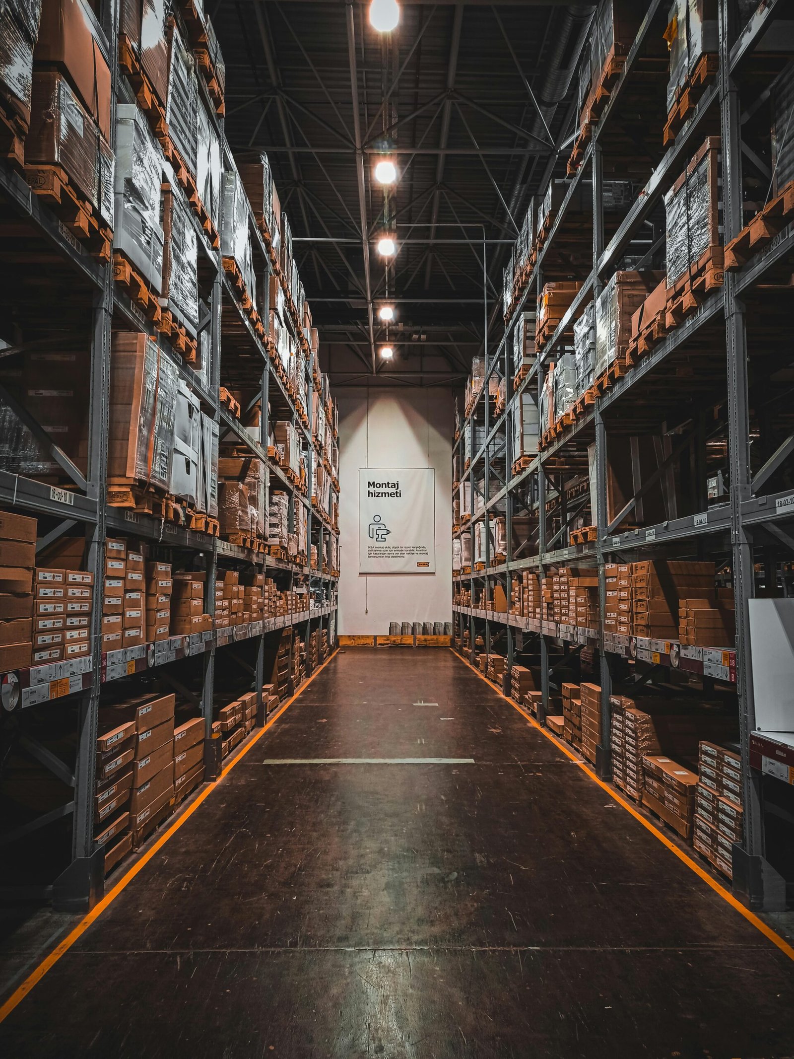 A well-organized warehouse aisle with stacks of goods on industrial storage racks, ensuring efficient logistics.